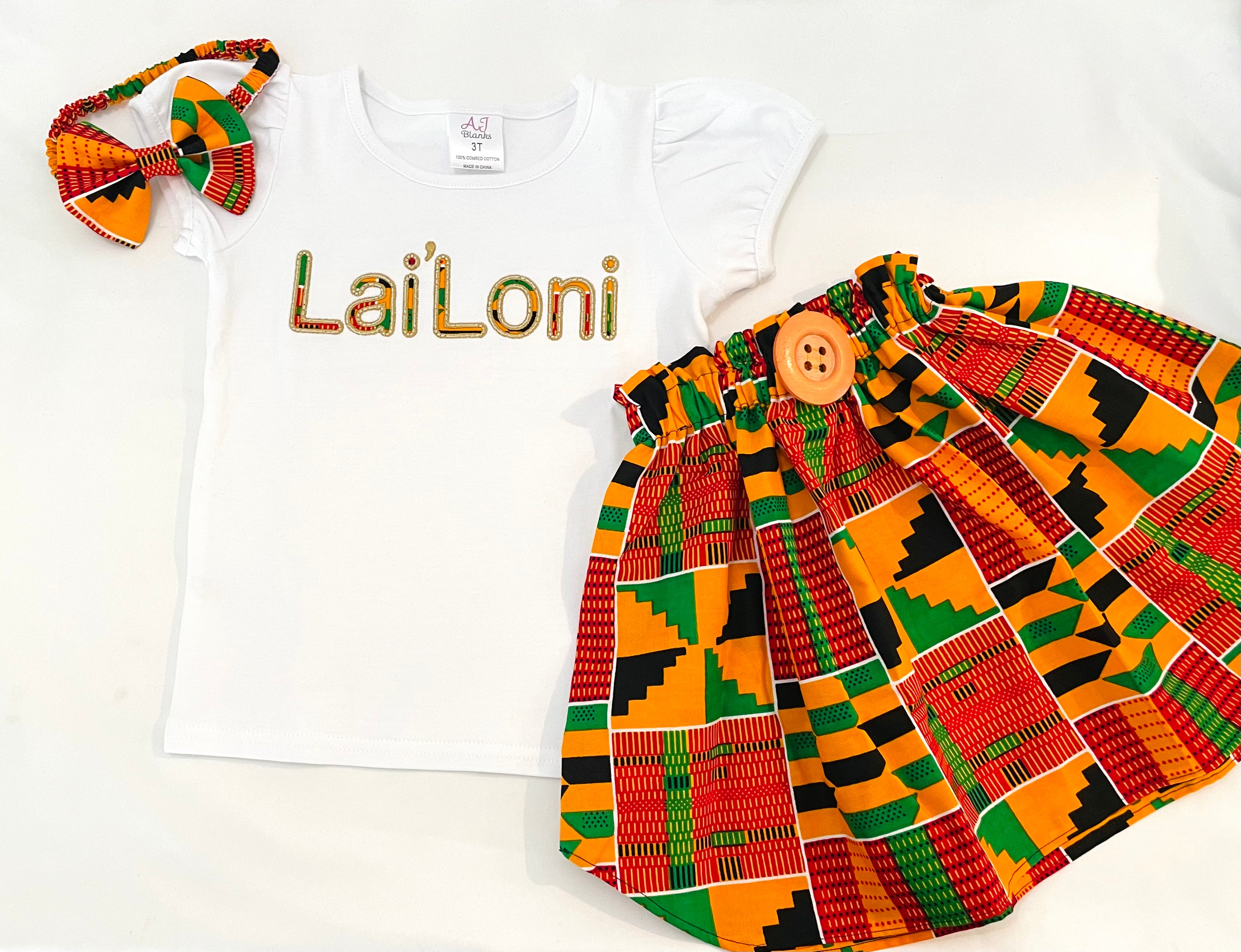 Girls' vibrant kente fabric skirt set with a personalized embroidered t-shirt and a matching headband
